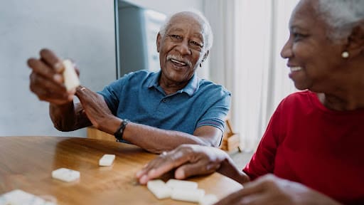 Senior couple playing dominoes