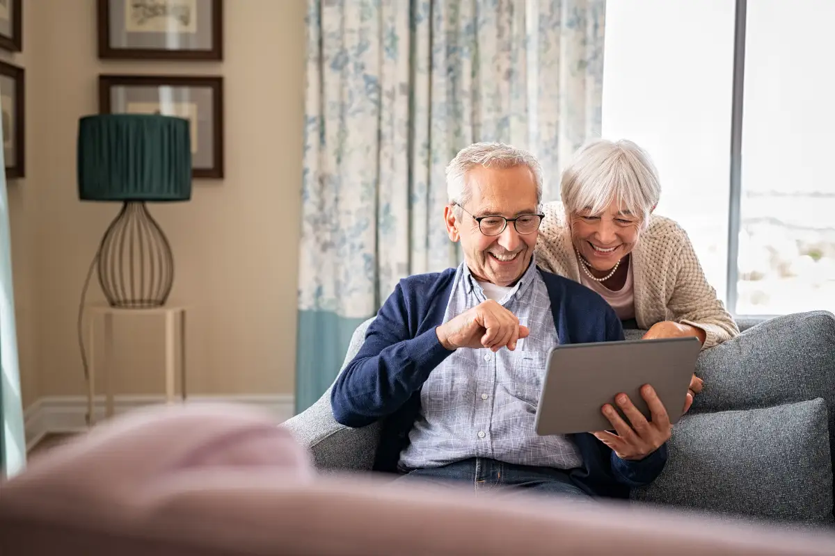 a senior couple video chatting with family on their tablet