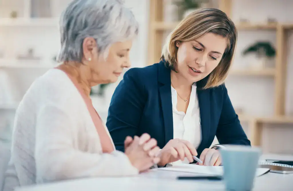 senior woman reviewing ccrc contract types with professional