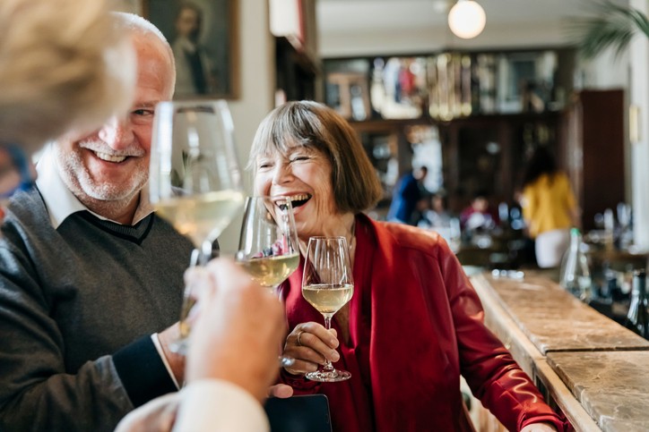 Senior friends drinking wine together in a luxury retirement community